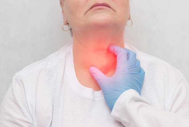 Doctor feels the thyroid gland in a patient of an adult woman, thyroid cancer, close-up, node Doctor feels the thyroid gland in a patient of an adult woman, thyroid cancer, close-up, probing, carcinoma lymph node photos stock pictures, royalty-free photos & images