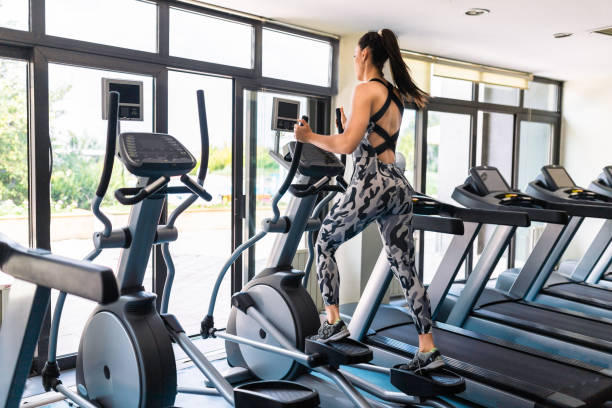 istock woman Training on Stair Stepper in Gym 1174575670
