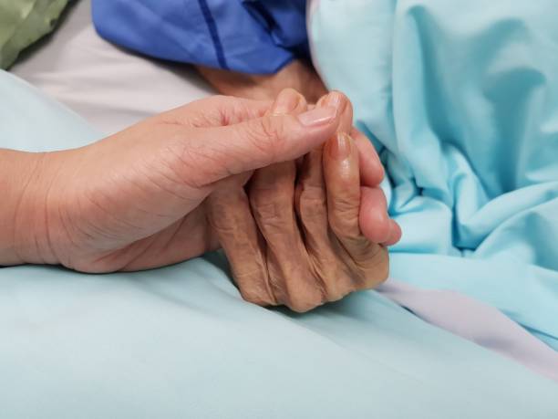 Holding grandmother's hand in the nursing care. Showing all love, empathy, helping and encouragement : healthcare in end of life and palliative concept end of life and palliative care lifestyle stock pictures, royalty-free photos & images