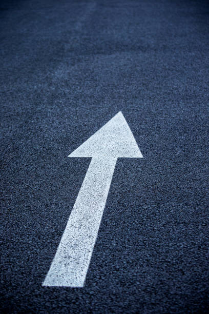 istock Arrow symbol on asphalt road 1174587142