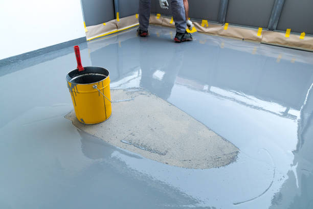 istock construction worker renovates balcony floor and spreads watertight resin and glue before chipping and sealing 1174587246