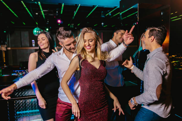istock Young people dancing in night club 1174587310