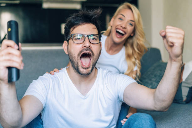 istock Excited couple watching tv 1174587723