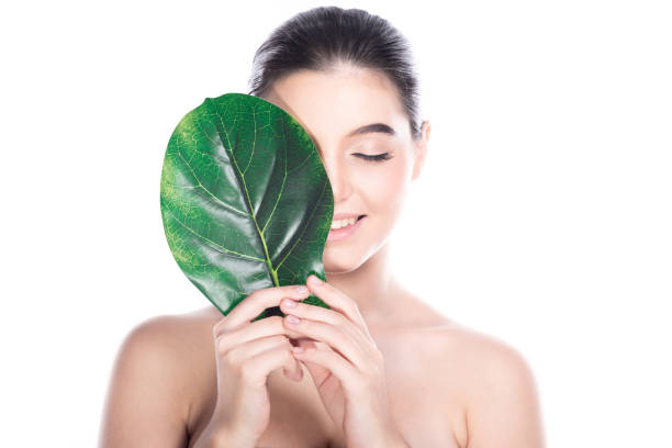 istock Beauty woman face with leaf. 1174588716