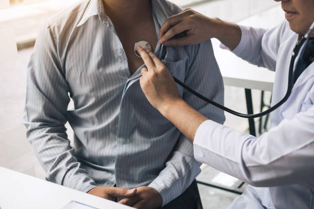 asian doctor is using a stethoscope listen to the heartbeat of the elderly patient. - physical checkup imagens e fotografias de stock