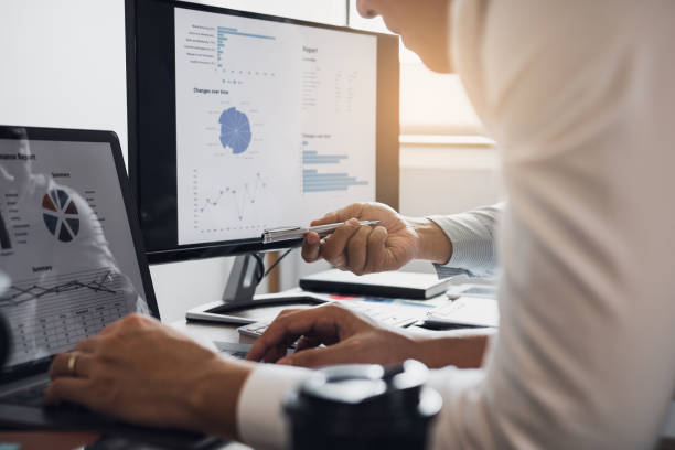 istock Colleagues are talking about the results in the documents on hand and compared with the financial information on the laptop screen. 1174589894