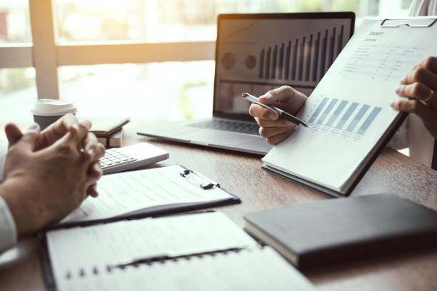 istock Business employee man are reporting about performance graphs summary and financial budget calculations for managers in the office. 1174590598