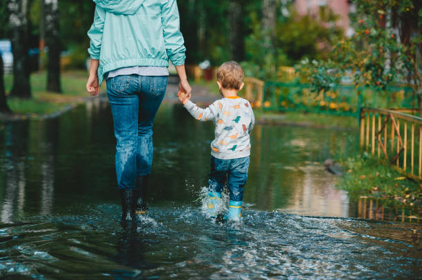 istock Walking in the street on a rainy day. Back view 1174590753