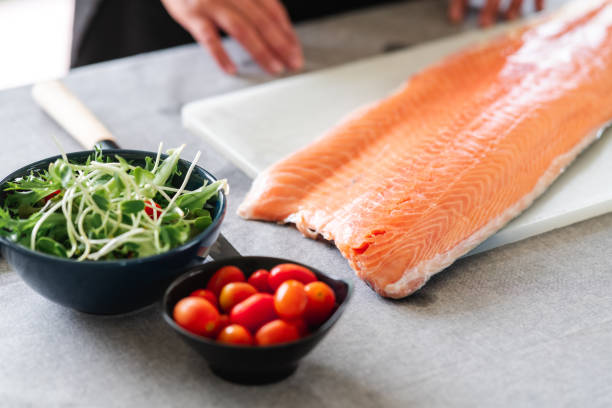 istock Woman chef preparing salmon sushi. 1174590947