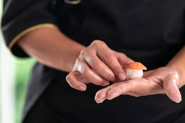 istock Sushi chef holding a salmon nigiri. 1174591097