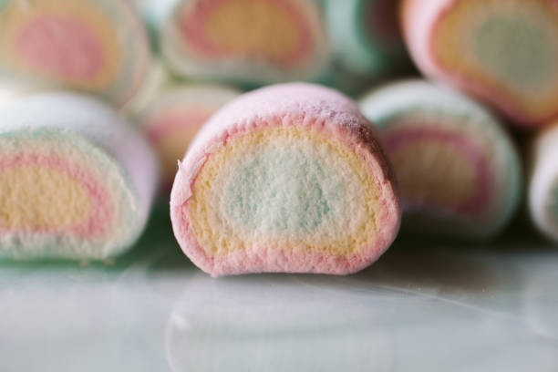 Colorful marshmallows as background. Close up of fluffy marshmallows texture with copy space. Candy background and texture for design.