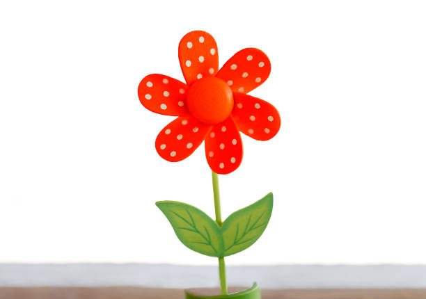 Single red wooden daisy isolated on white background.