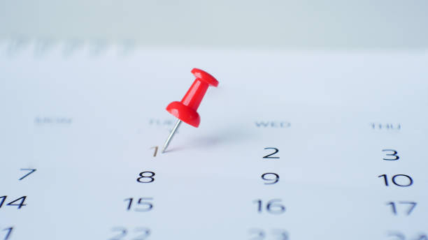 istock Red pin marking on calendar in planning concept. 1174595602