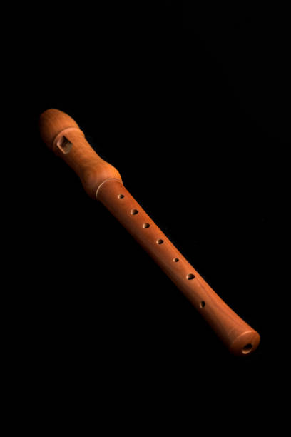 wooden flute on a black background