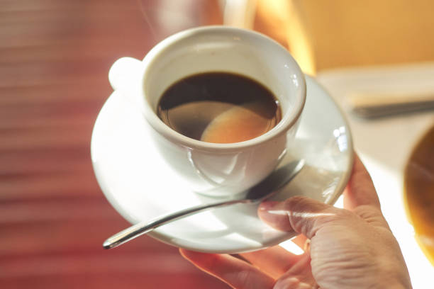 istock Cup with morning coffee in female hand 1174603199