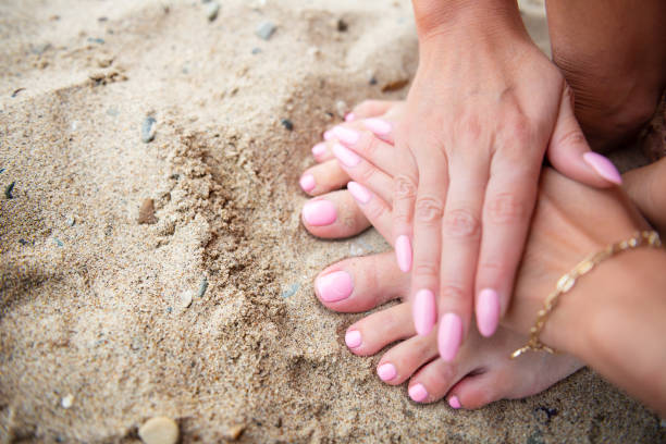 istock Young lady is showing her light pink manicure and pedicure nails 1174603275