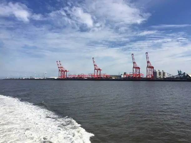 Photo of Container cranes, a type of large dockside gantry crane found at container terminals for loading and unloading intermodal containers from container ships, in the port of Liverpool