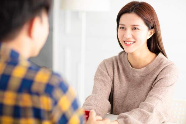 istock Happy young couple  talking and laughing, drinking tea. 1174606418