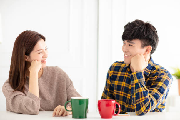 istock Happy young couple  talking and laughing, drinking tea. 1174606535