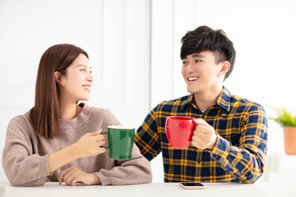istock Happy young couple  talking and laughing, drinking tea. 1174606624