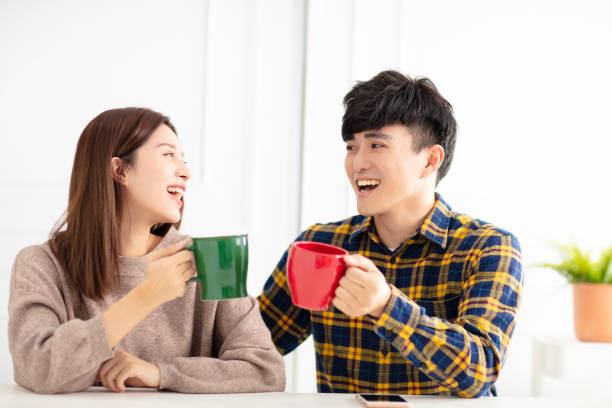 istock Happy young couple  talking and laughing, drinking tea. 1174606714