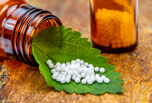 istock alternative medicine with homeopathy and herbal pills 1174606723