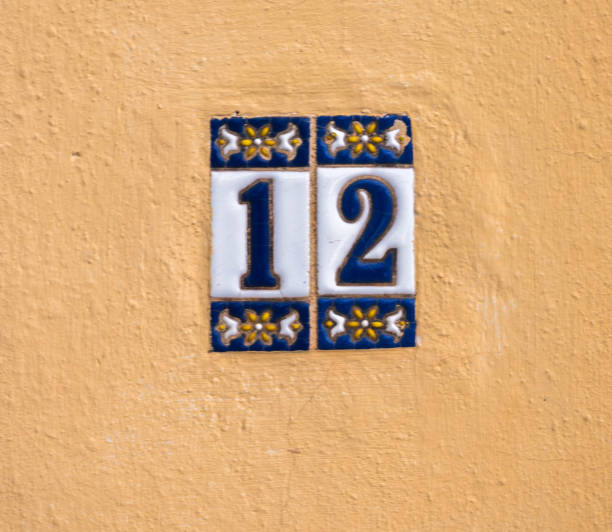istock Decorative ceramic house number 12 tile on the wall, characteristic decorative element 1174610547