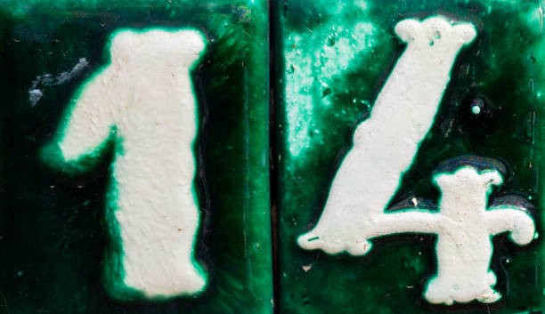 istock Decorative ceramic house number 14 tile on the wall, characteristic decorative element 1174610584