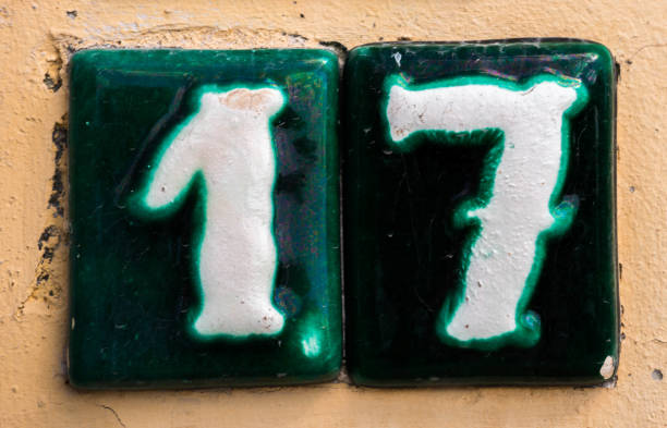 Decorative ceramic house number 17 tile on the wall, characteristic decorative element