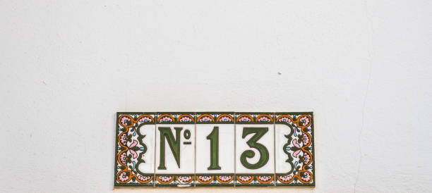istock Decorative ceramic house number  N13 tile on the wall, characteristic decorative element 1174610617