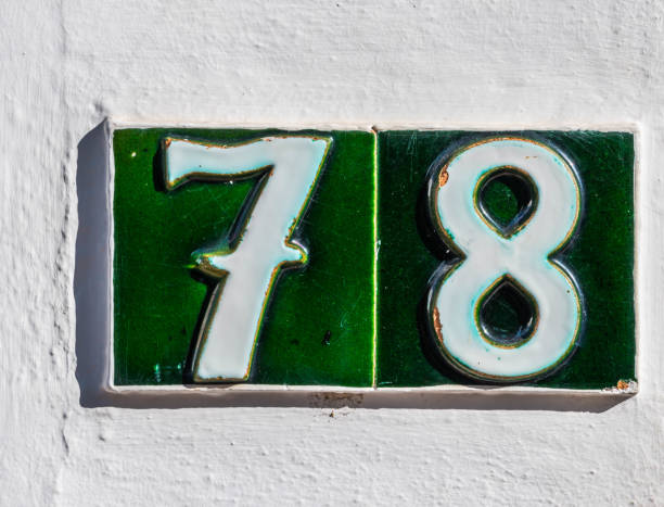 istock Decorative ceramic house number 78 tile on the wall, characteristic decorative element 1174610628