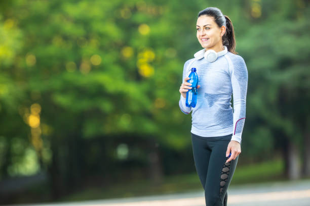 istock Young female athlete drinks water after training. 1174614702