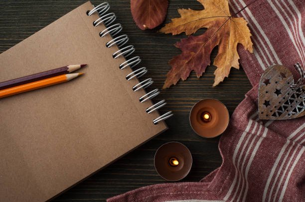 istock autumnal leaves and lit candles 1174615352