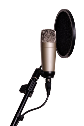 A large diaphragm studio microphone with pop filter screen with white background