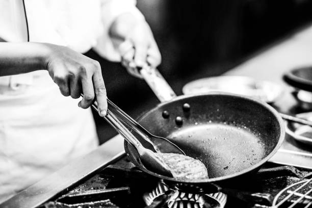 istock chef preparing food, chef cooking in a kitchen, chef at work, Black & White 1174615882
