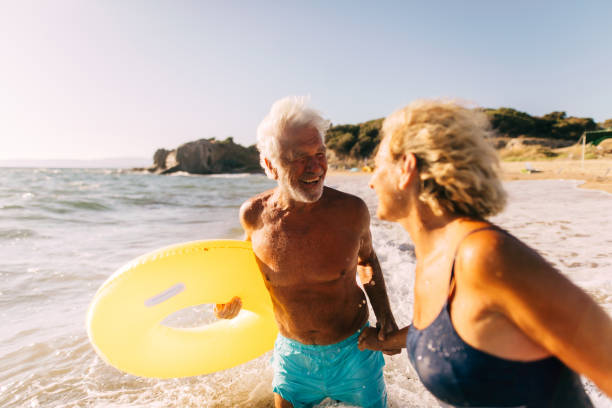 istock Playful senior couple on the beach 1174618829