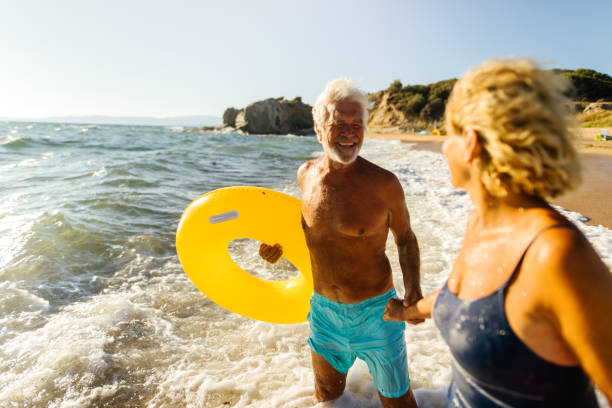 istock Playful senior couple on the beach 1174618890