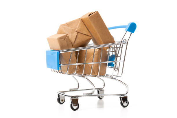 istock Online shopping concept. Shopping cart with small boxes inside on white background 1174622992
