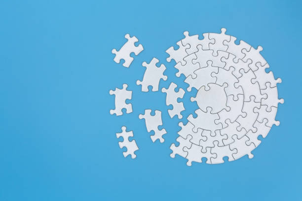 istock Unfinished white jigsaw puzzle pieces on blue background,  Copy space. 1174625910