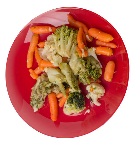 istock provencal vegetables on a plate.grilled vegetables on a plate isolated on white background.broccoli and carrots on a plate top view.healthy  food 1174628930