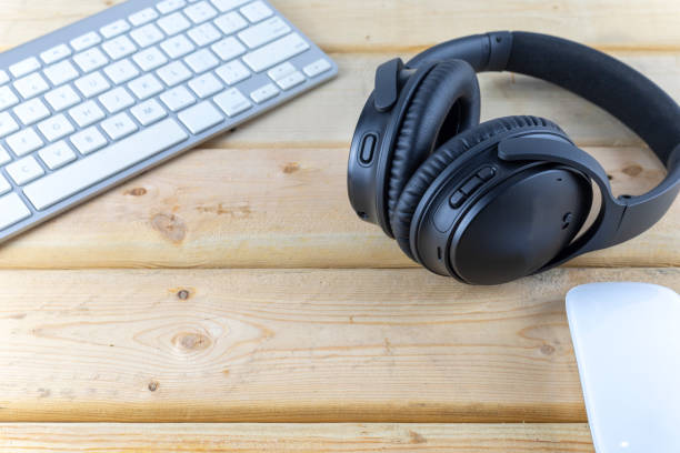 istock Headphones and laptop on wood table. With copy space for text or design. Technology concept. 1174629011