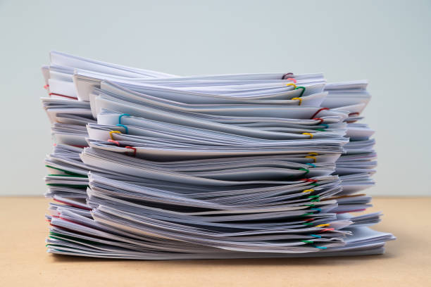 istock Stack of document paper with colorful paperclip place on wooden table. 1174629361