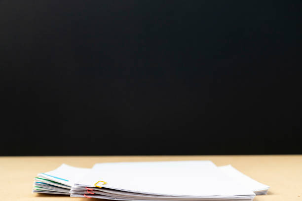 istock Stack of document paper with colorful paperclip place on wooden table. 1174629368