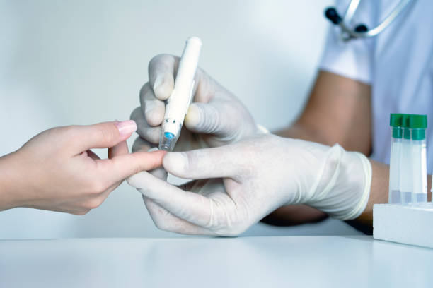 istock Doctor checking blood sugar level, doctor using lancet on finger, testing blood glucose 1174630017