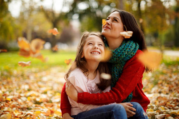 istock Mother and daughter playing in the park 1174634302