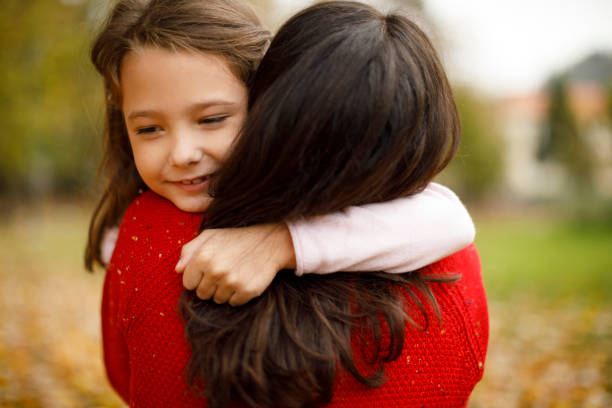 Mother and daughter playing in the park Mother and daughter playing in the park foster care stock pictures, royalty-free photos & images