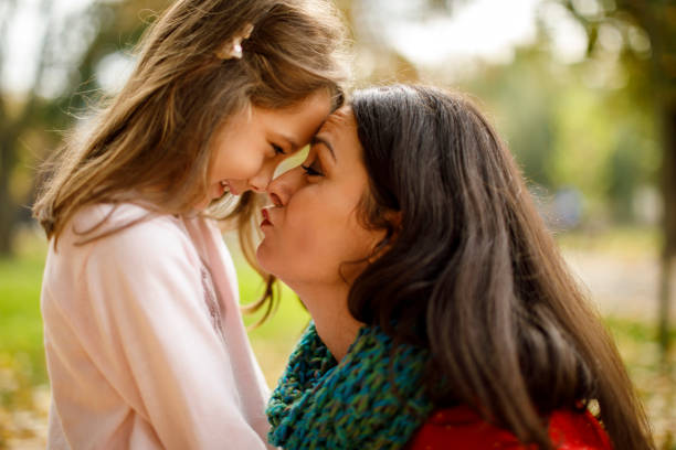 istock Mother and daughter playing in the park 1174634436