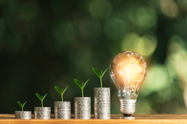 istock Light bulb with stack of coins and copy space for accounting, business and creative concept. 1174634554