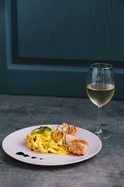 Chicken meat with pasta and pesto sauce Shot on natural light. Dark food concept cooked selective focus vertical pasta stock pictures, royalty-free photos & images