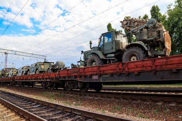 istock Cargo train carrying military vehicles on railway flat wagons 1174639001